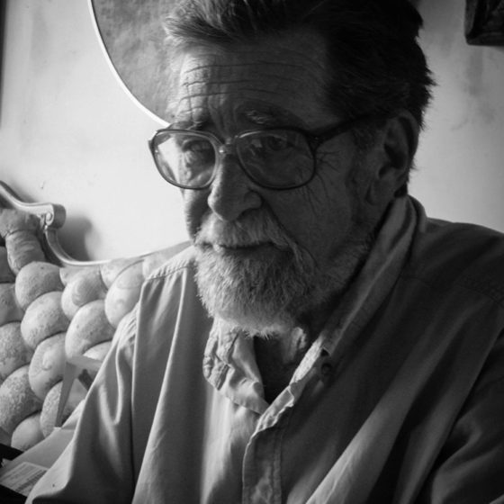 Black and white portrait of older man with glasses and beard