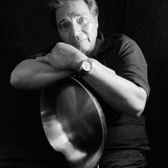 Black and white photograph of chef holding pan